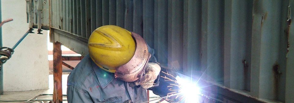 Container repair technicians working in a depot yard