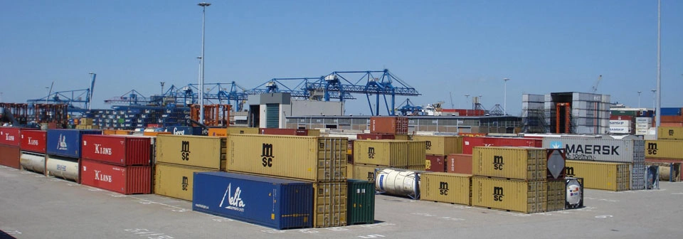 Engineers inspecting and repairing a shipping container in a depot